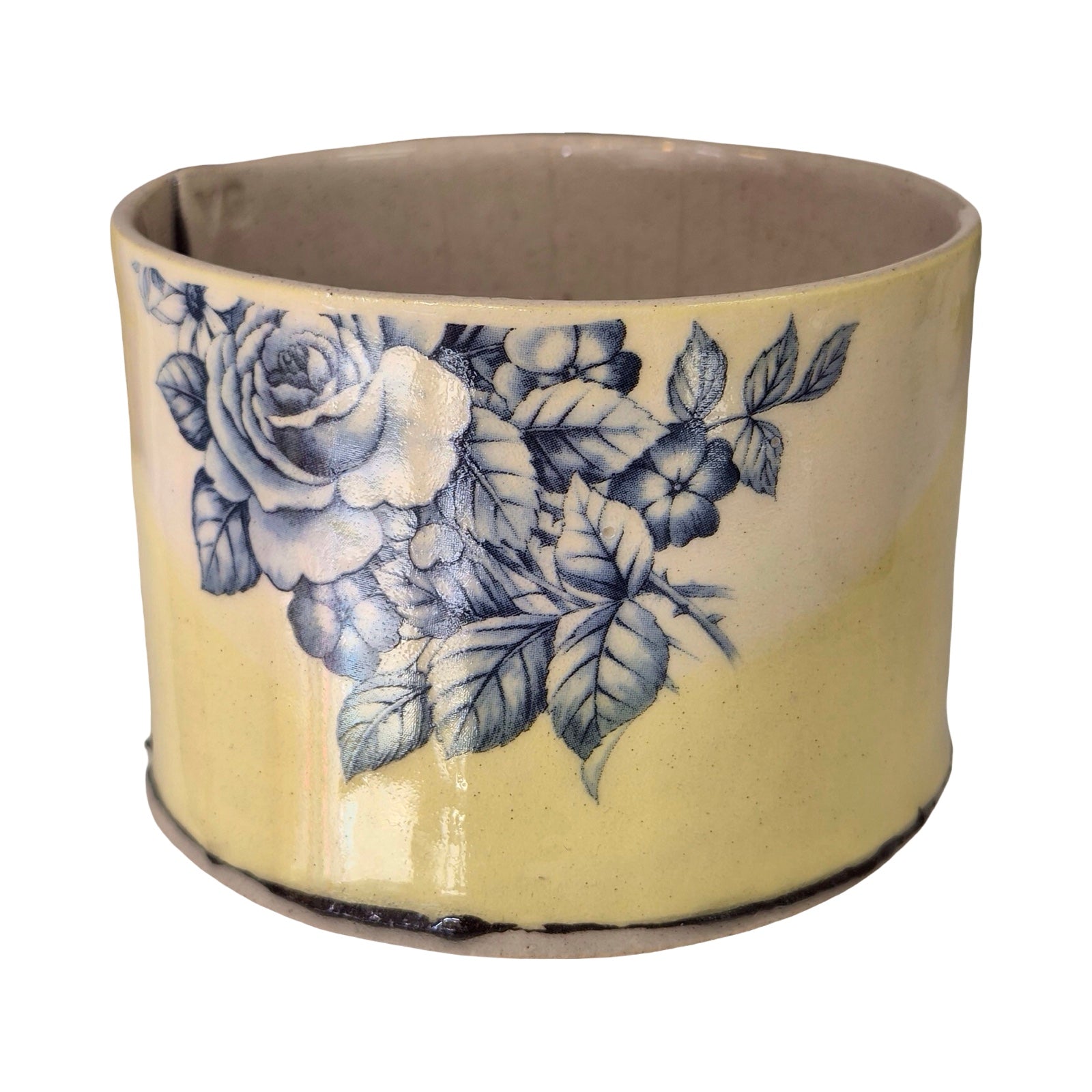 Ceramic planter with blue floral design on a white background.