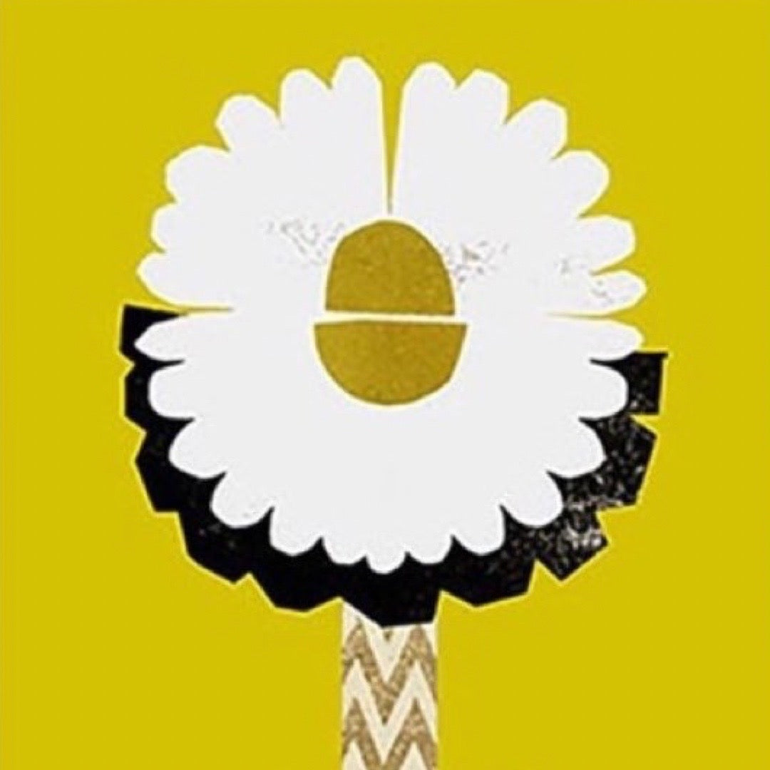 Decorative flower with white petals, yellow center, and black and gold accents on a yellow background.