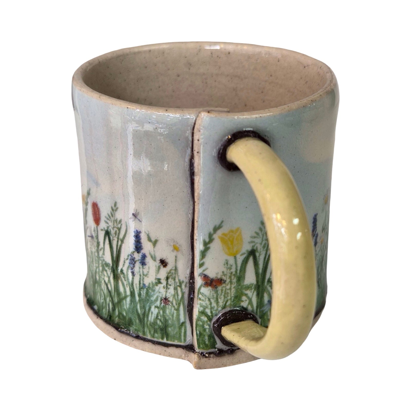 Ceramic mug with a natural scene design on a white background.