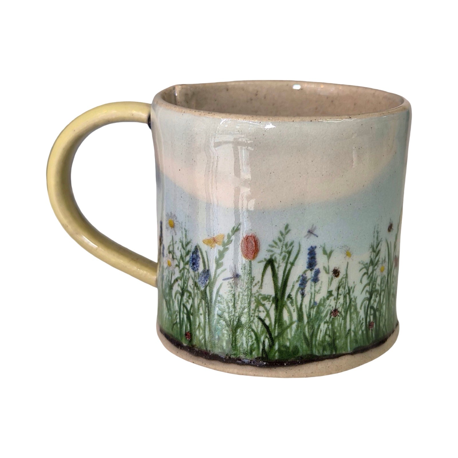 Ceramic mug with a floral design on a white background.