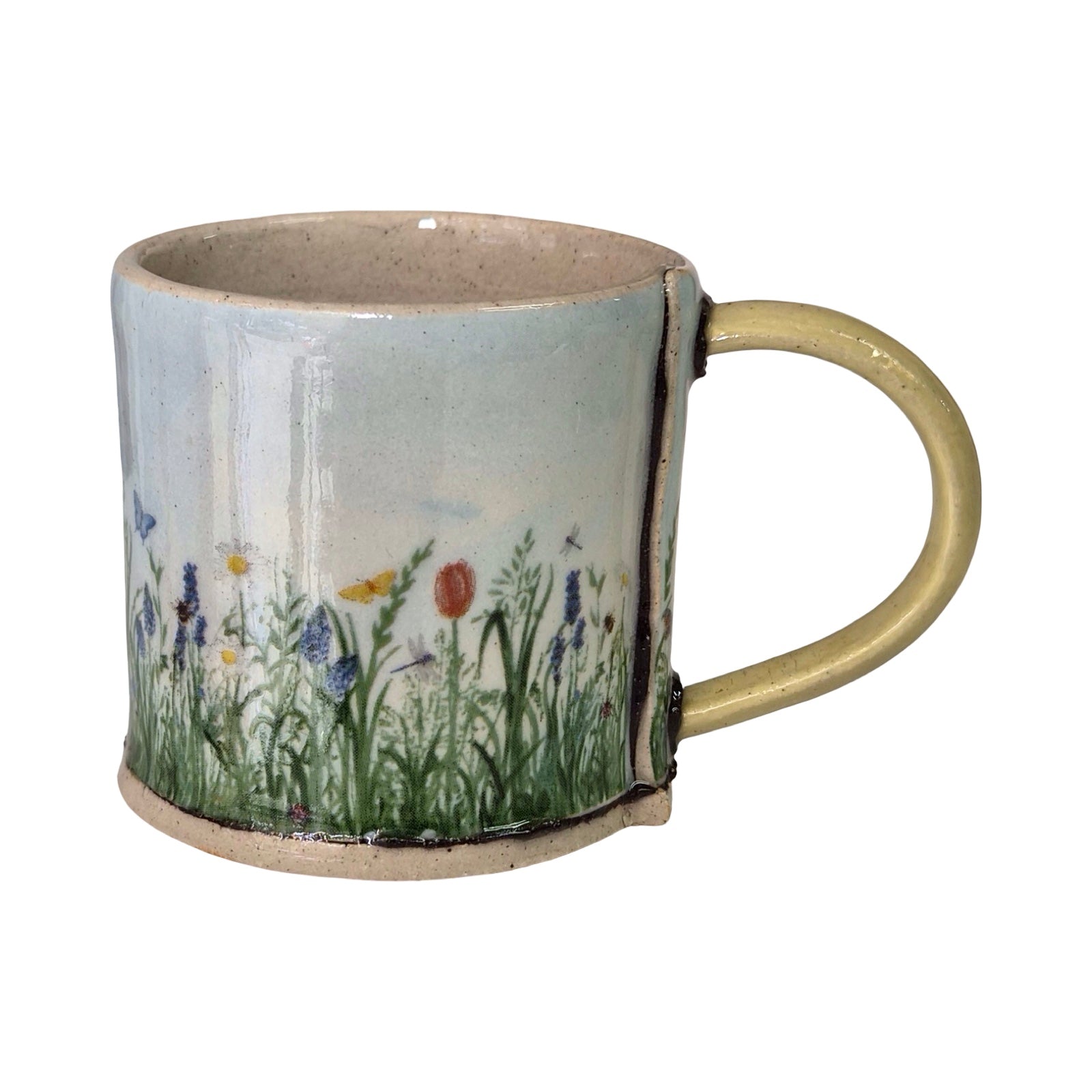 Ceramic mug with floral design on a white background.