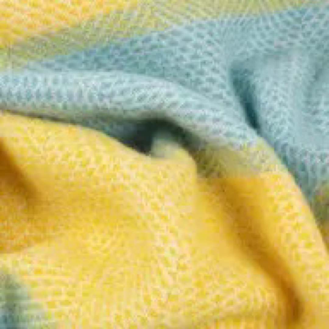 This yellow and pale blue striped super cosy and fluffy blanket is made from 100% pure new wool and finished with extra brushing to make it super soft.