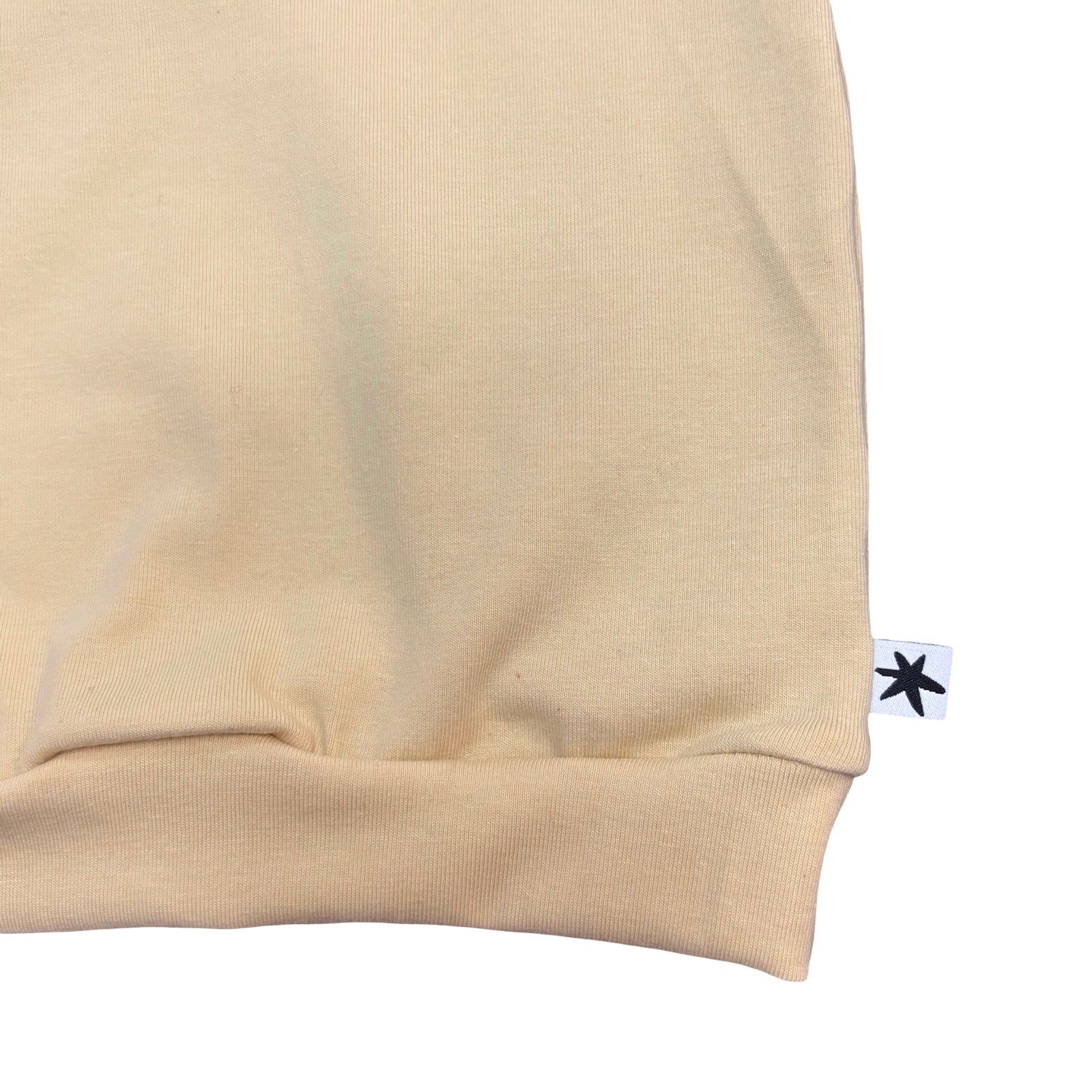 Yellow t-shirt with a brand label on a white background.