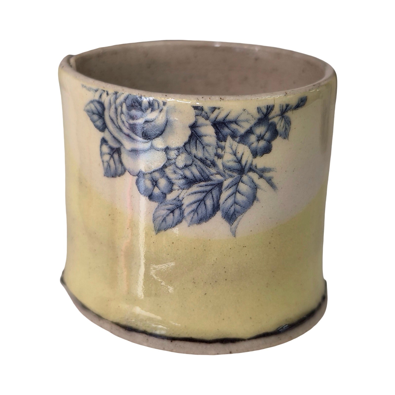 Ceramic planter with blue floral design on a white background.