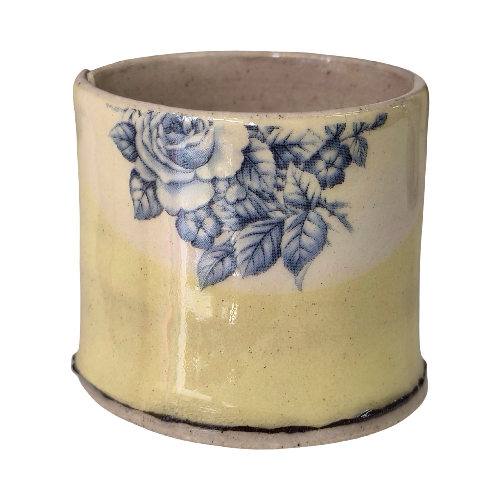 Ceramic planter with blue floral design on a white background.