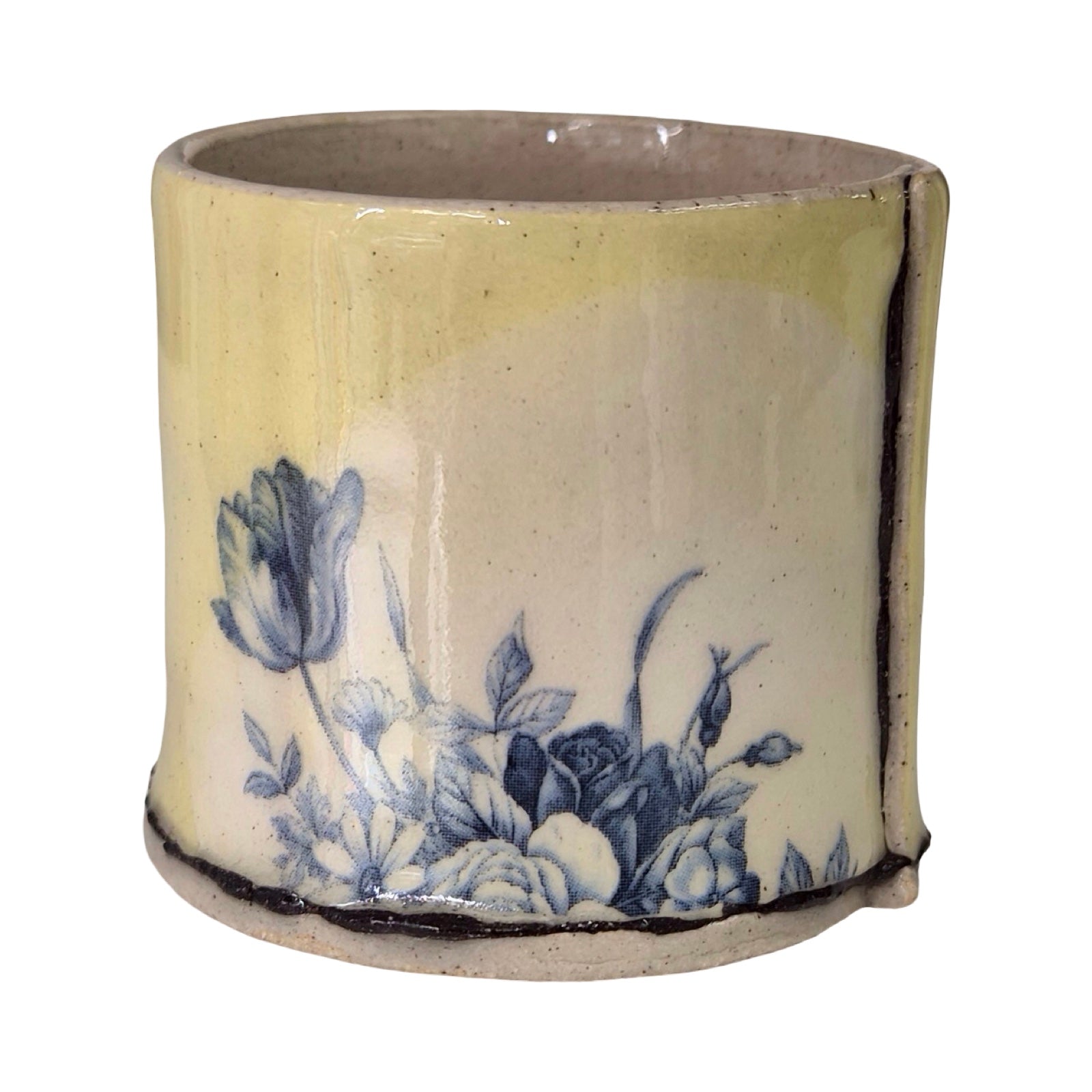Ceramic planter with blue floral design on a white background.