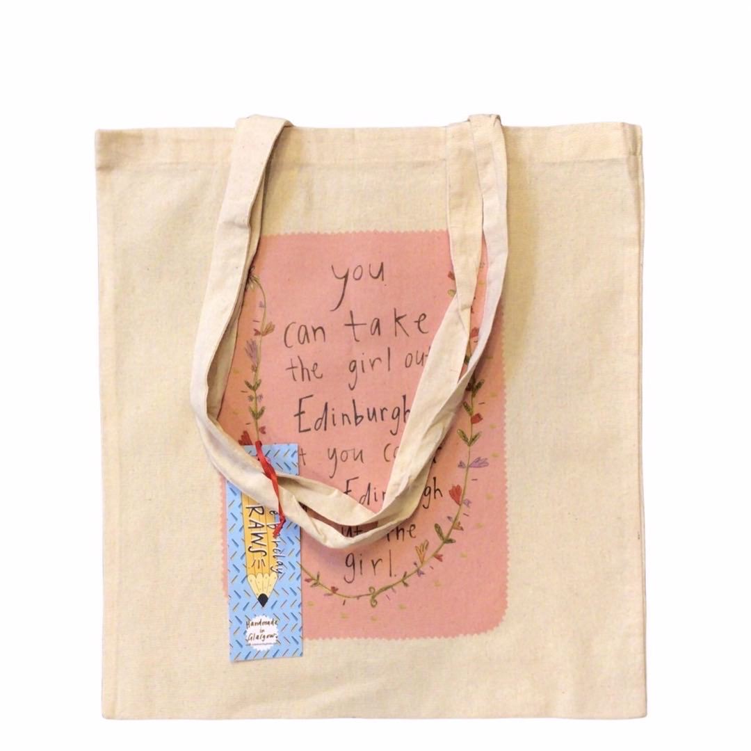 The perfect tote bag for Edinburgh gals everywhere, with the text 'You can take the Girl Outta Edinburgh, but you can't take the Edinburgh out the girl' surrounded by flowers on a pink background.